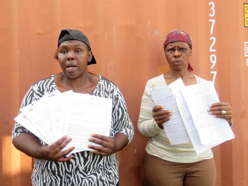 From left: Sizakele Mavuso and Lillian Moloto hold up protection orders they obtained against the alleged sex pest. Photo   by Ntebatse Masipa