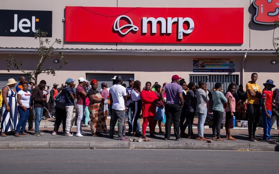 People queue close to each other outside a shopping centre in Philippi, Cape Town, on Monday (March 30 2020). Picture: Roger Sedrus/Gallo Images