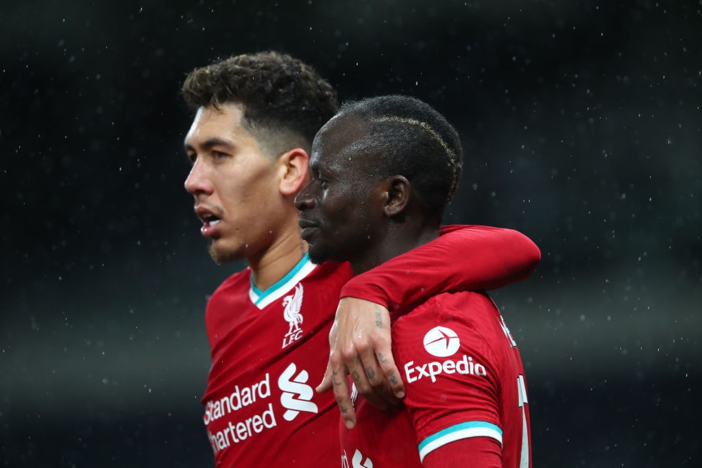 LONDON, ENGLAND - JANUARY 28: Sadio Mane of Liverpool celebrates with Roberto Firmino during the Premier League match between Tottenham Hotspur and Liverpool at Tottenham Hotspur Stadium on January 28, 2021 in London, United Kingdom. Sporting stadiums around the UK remain under strict restrictions due to the Coronavirus Pandemic as Government social distancing laws prohibit fans inside venues resulting in games being played behind closed doors. (Photo by Marc Atkins/Getty Images)