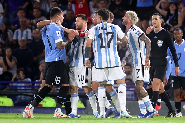 Lionel Messi clashes with Uruguay's Mathias Oliver