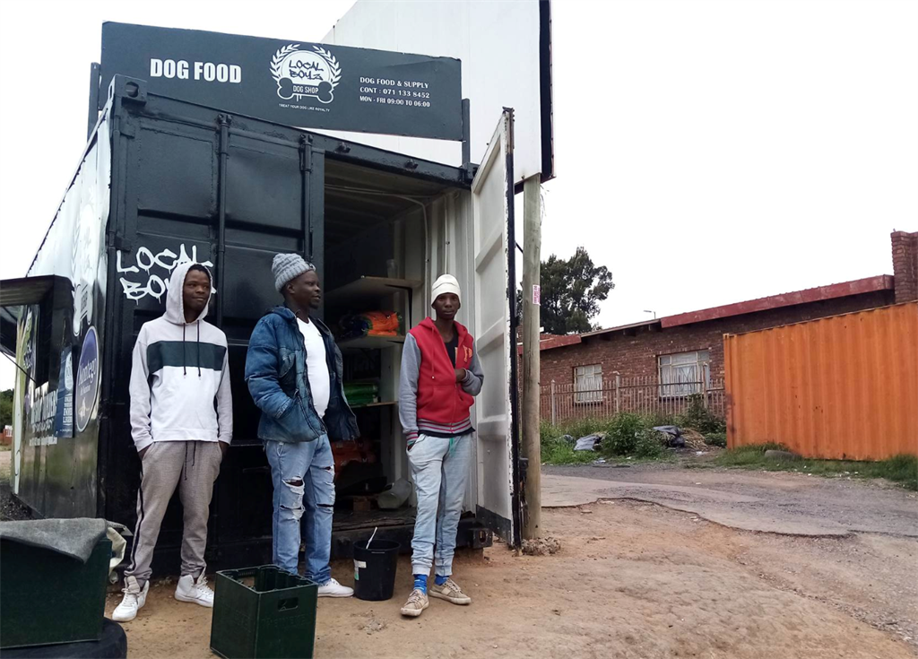 Thabo Mogale, Tebogo Molefe and Peterjie More stand outside the Local Dog Shop. Picture: Molebogeng Mokoka/City Press