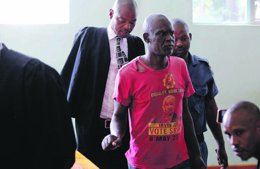 Murder-accused Lucas Phasha being escorted into the courtroom by the police.        Photo by Joshua Sebola