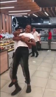 A screenshot of an employee being removed by a security guard after getting into a fight. .
Image: Screenshot