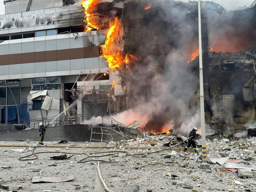 This handout photograph, taken and released by the Ukrainian Emergency Service on 29 December 2023, shows firefighters working in a burning building at a site following an attack in Dnipro, amid the Russian invasion of Ukraine. Russia launched drone and missile strikes across Ukraine on 29 December 2023, killing at least 30 people and wounding over a hundred in one of the most massive air attacks of the war. 
