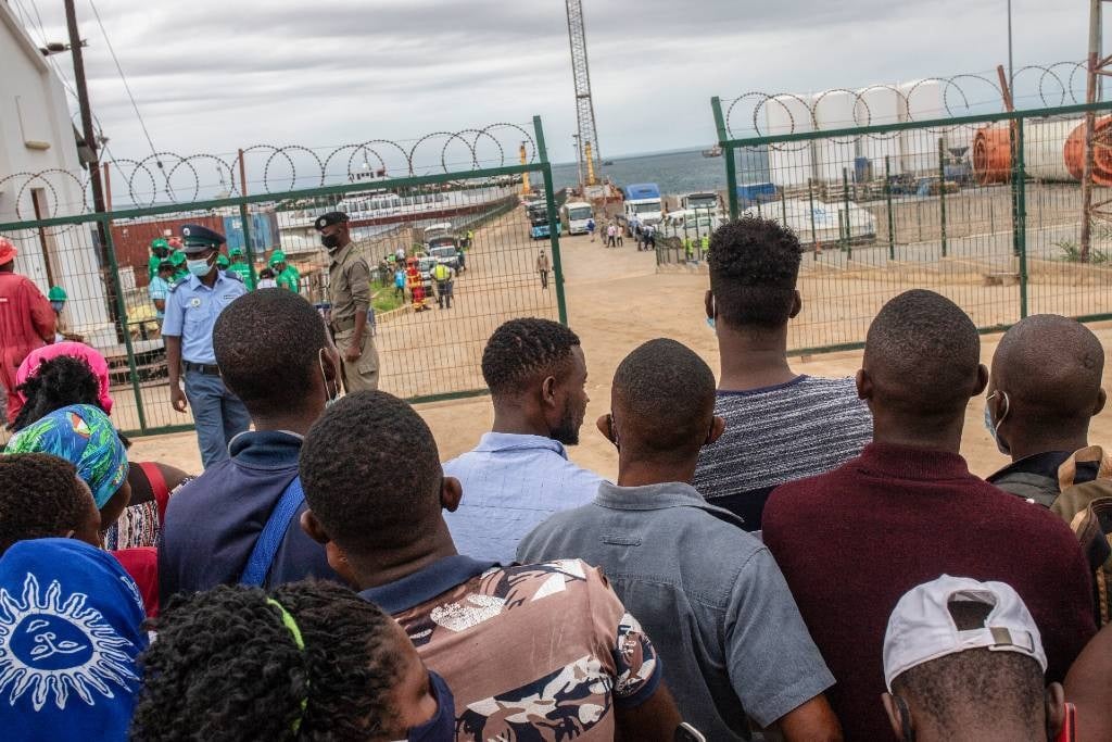 People wait for their relatives and friends to arrive in Pemba on 1 April 2021, from the boat of evacuees from the coasts of Palma, Mozambique.