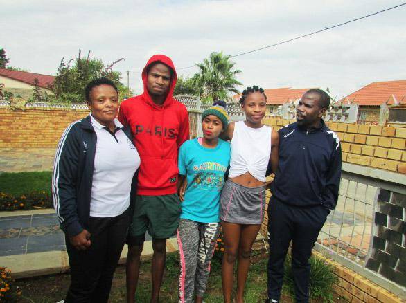 Mothusiemang Moepeng (in blue tracksuit), his wife Ntombizodwa (in blue Adidas track top) and their children Ketshepile (in red hoodie top), Didintle (white top) and Sarah (in light blue top and woolen hat) outside their house in Mahikeng. Picture: Poloko Tau